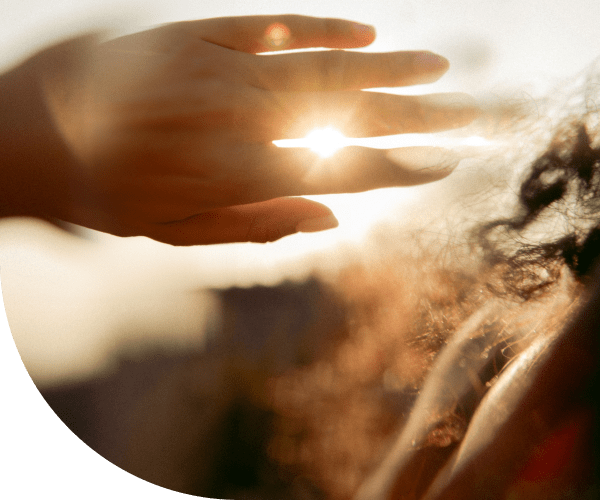 Hand covering sun